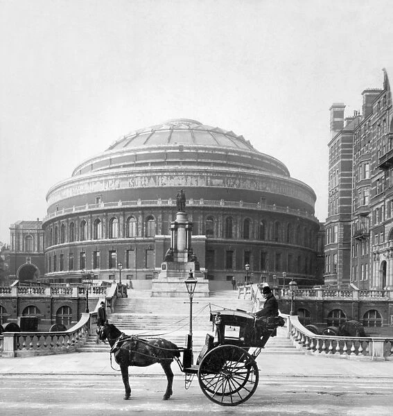 LONDON: ALBERT HALL, c1904. Horse and cart outside the Royal Albert Hall rotunda in London