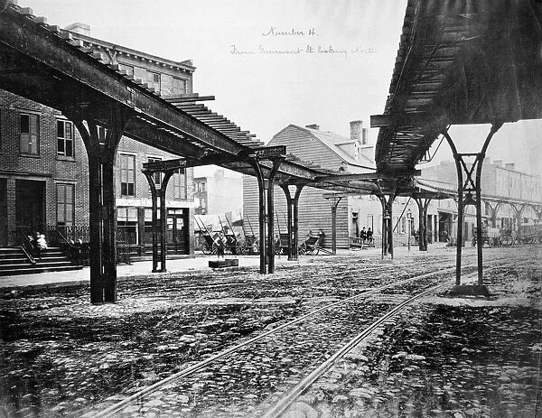 NEW YORK: NINTH AVENUE. View looking north from Gansevoort Street of the intersection at Little West 12th Street where Greenwich Street turns into Ninth Avenue, with tracks of the Greenwich Street-Ninth Avenue elevated railroad line running overhead. Photographed in 1876