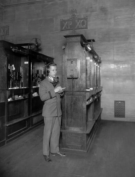 NEW YORK STOCK EXCHANGE. Telephone operator at booth of new quotation system. Photograph