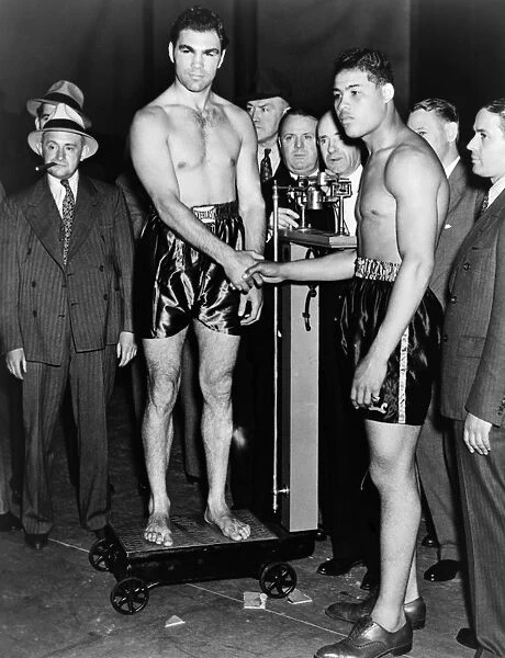 SCHMELING AND LOUIS, 1936. Boxers Joe Louis and Max Schmeling shake hands before