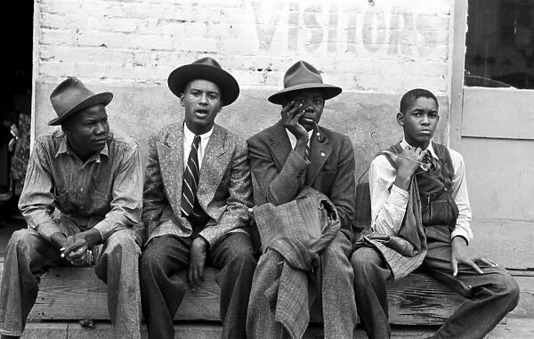 TEXAS: YOUNG MEN, 1939. Four young African American men seated on a bench, Waco Texas