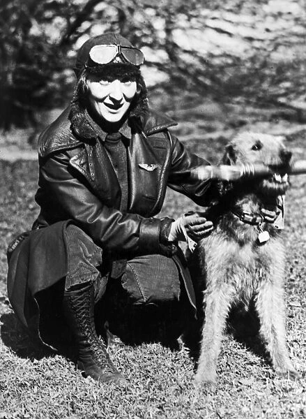 An unidentified female aviator, posed with President Warren G. Hardings dog, Laddie Boy. Photograph, c1922