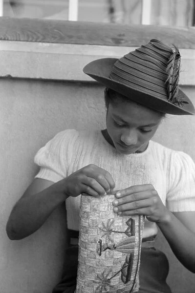 VIRGIN ISLANDS: CRAFTS, 1941. A woman embroidering a handbag at a handicrafts cooperative