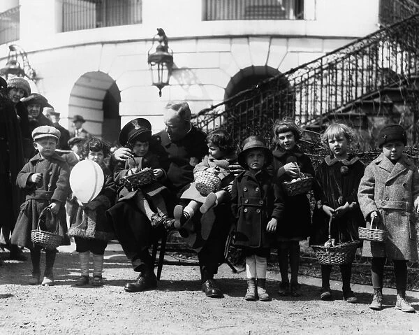 WHITE HOUSE: EASTER, 1923. White House police officer Edgar Porter watching a group