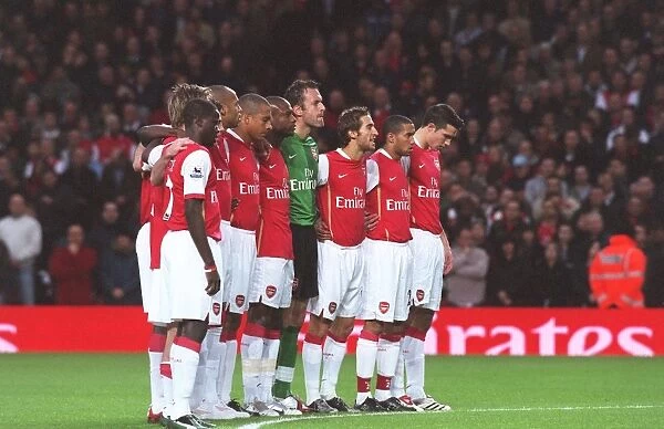 The Arsenal players line up for a minutes silence for Rememberence Day before the match