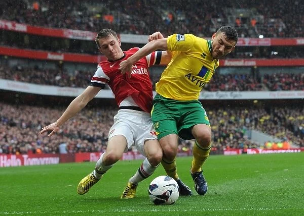 Arsenal's Aaron Ramsey Tackles Norwich's Robert Snodgrass in Premier League Clash