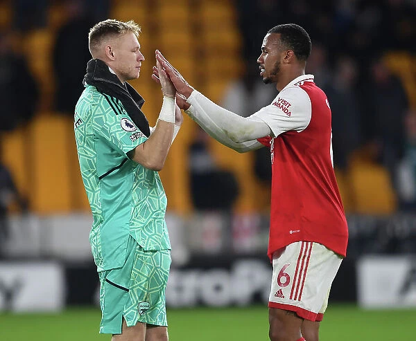 Arsenal's Gabriel Magalhaes and Aaron Ramsdale Celebrate Victory over Wolverhampton Wanderers in the 2022-23 Premier League