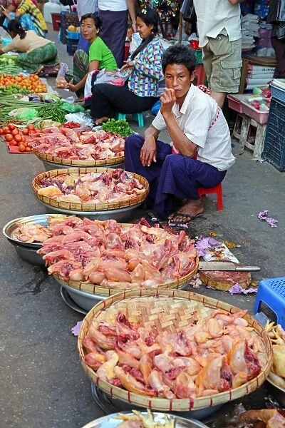 Man selling chicken in a street market, Yangon, Myanmar