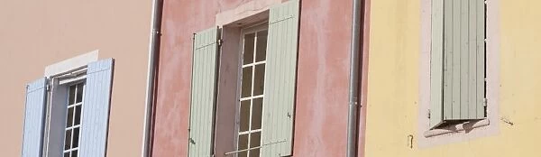 Windows and colourful walls at Rousillon in France