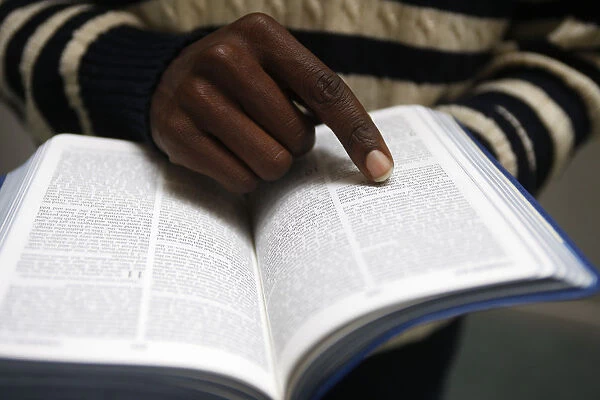 African man reading the bible in a church