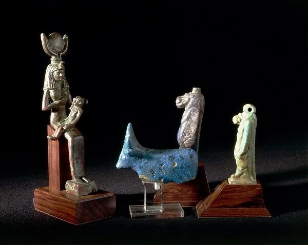 Amulets of deities Hathor and Taweret, and statuette of Isis nursing infant Horus