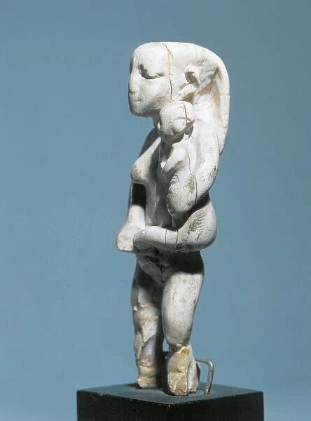 Ancient Egyptian ivory statuette of woman holding child in arms, Predynastic Period, 3100-3000 B. C
