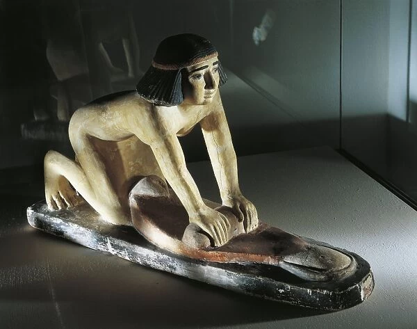 Ancient Egyptian painted limestone model statuette of woman grinding wheat, Old Kingdom, V Dynasty