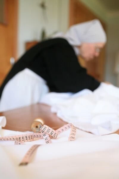 Benedictine nun making religious vestment