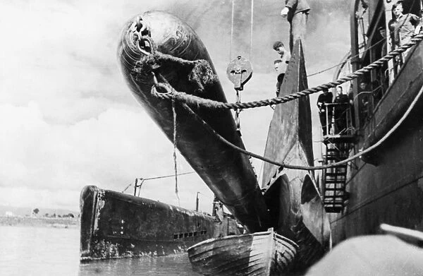 Black sea fleet, a torpedo being loaded onto a submarine during world war 2, august 1943