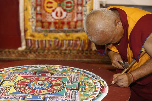 Buddhist monk drawing a mandala