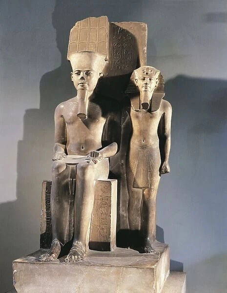 Calcite sculptural group portraying pharaoh Tutankhamen standing beside enthroned god Amon from Thebes, New Kingdom, Dynasty XVIII