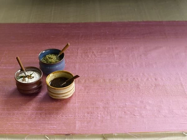 Chutneys in pots on silk cloth