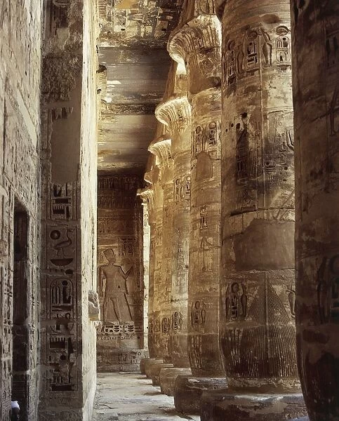 Egypt, Ancient Thebes, Medinet Habu, Temple of Ramses III, first courtyard, south porch, columns with capitals in the form of open papyrus flower and reliefs
