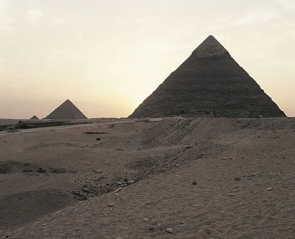 Egypt, Cairo, Ancient Memphis, Pyramids at Giza. Pyramid of Khafre (greek: Chephren) and Pyramid of Menkaure (greek: Mykerinus) in the background, sunset
