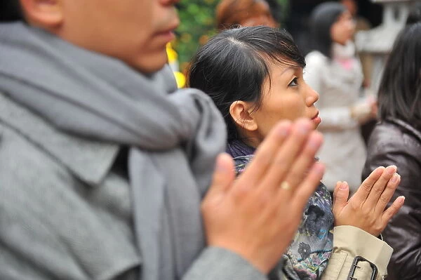 Faithful praying in a Hanoi buddhist temple