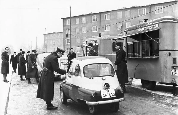The first west berliners crossing over at the sonnenallee checkpoint to visit relatives in east berlin in accordance with a recently signed treaty allowing such visits, december 1963