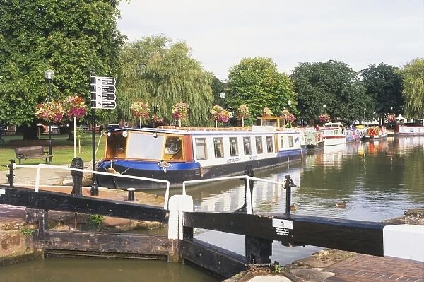 Great Britain, England, Warwickshire, Stratford-Upon-Avon, boat filled canal basin with tree lined causeway