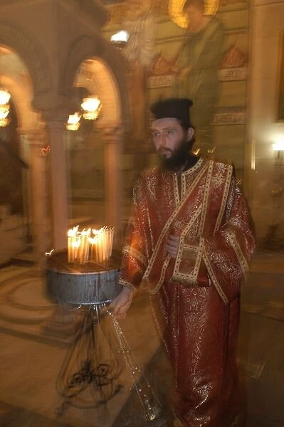 Greek orthodox priest in the Holy Sepulcher basilica in Jerusalem