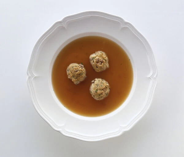 Leberknoedelsuppe, bowl of broth containing three dumplings made from beef liver