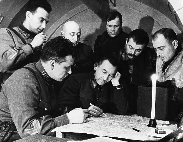 Lieutenant-generat pavel belov (center) going over battle plans at his headquarters, world war ll