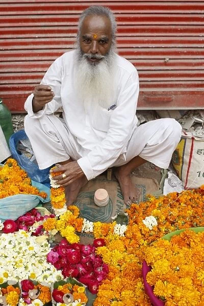 Man making & selling garlands