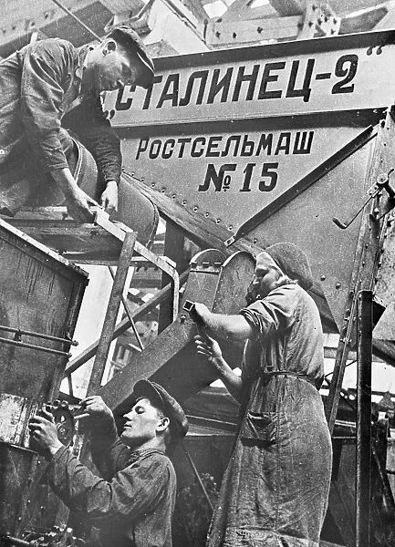 Men and women at work on a combine harvester in a factory at Rostov-on-Don, Union