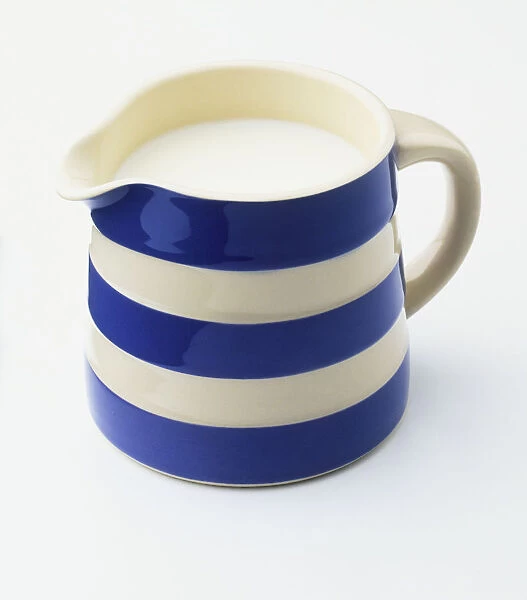 Milk in blue and white striped jug