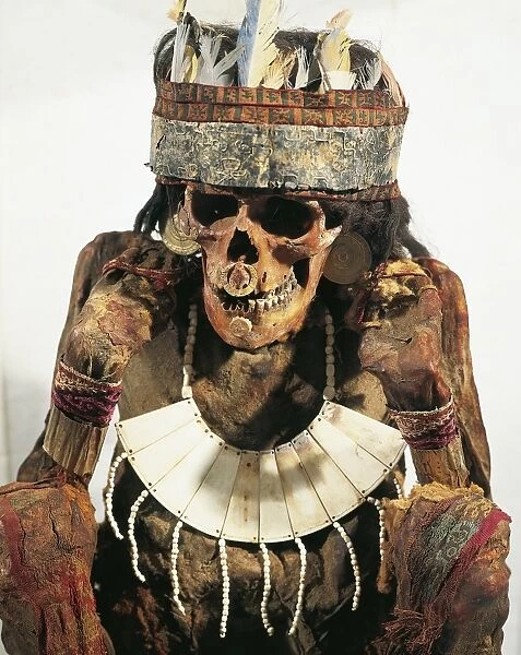Mummy of woman of Necropolis decorated with gold and bone jewels and feather headdress, circa 200 B. C