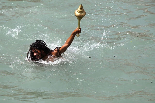 Naga sadhu bathing in the river Ganges on the occasion of Somvati Amavasya, a no moon day in the traditional Hindu calendar