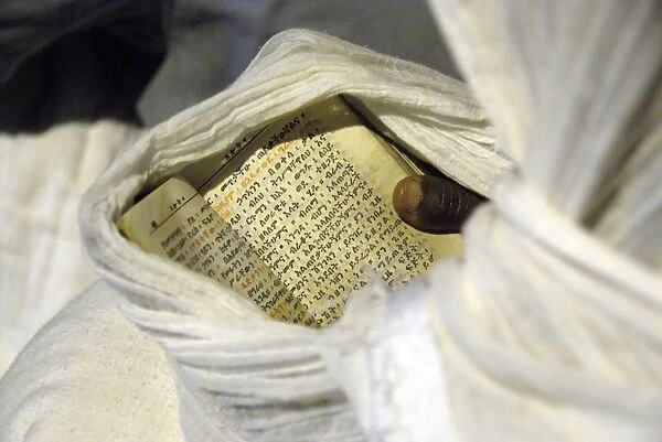 Pilgrim reading aprayer book in Lalibela