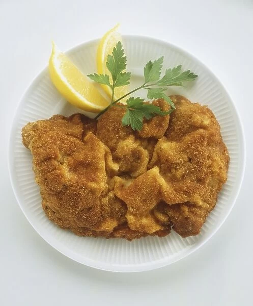 Plate of breaded veal or pork escalopes, Wiener schnitzel, with lemon and parsley leaf