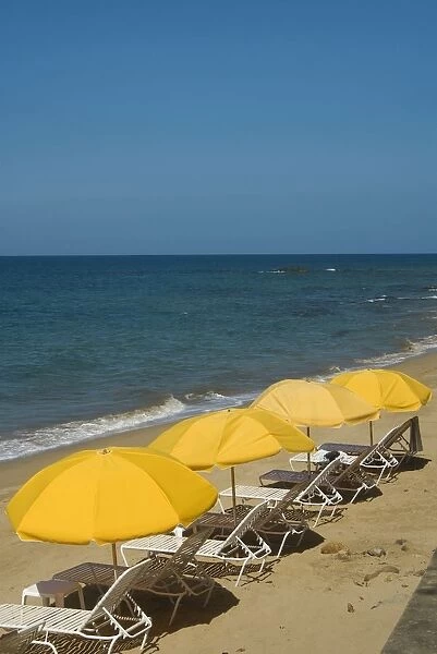 Puerto Rico, Rincon, deckchairs and umbrellas on sandy beach