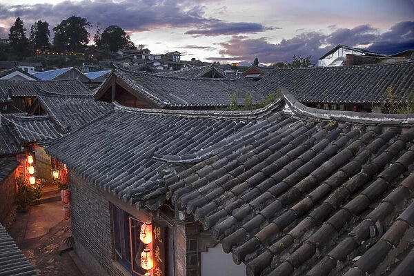Roofs and lanterns of the historic Baisha Old Town of Lijiang, China, at dusk