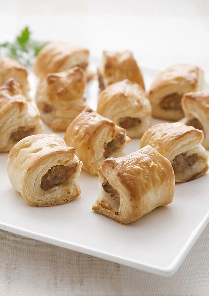 Sausage rolls on square plate, close-up