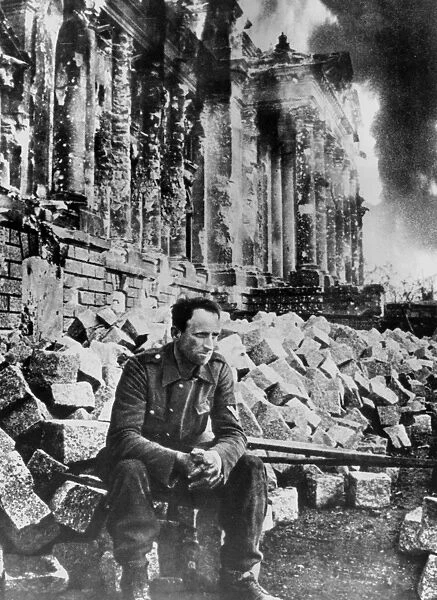 Second World War: German soldier sits amongst the ruins of the Reichstag in Berlin