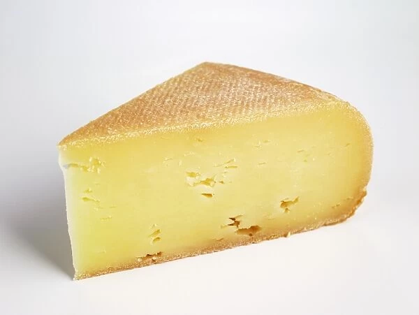 Slice of semi-soft French Bergues cows milk cheese