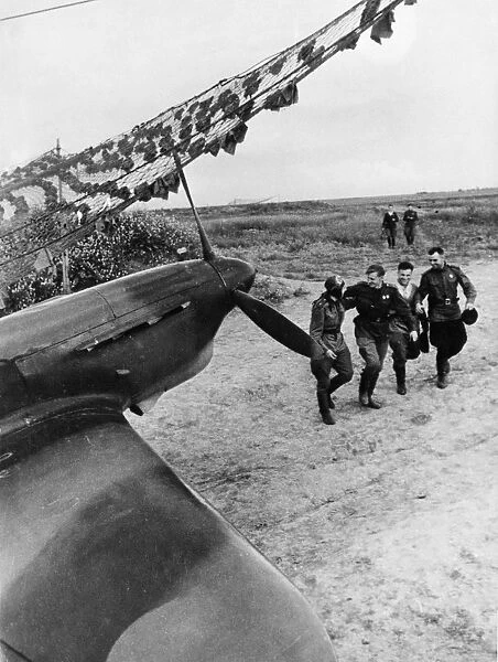 Soviet pilots greeting each other after a mission, yakovlev yak fighter of the soviet air force is in the foreground