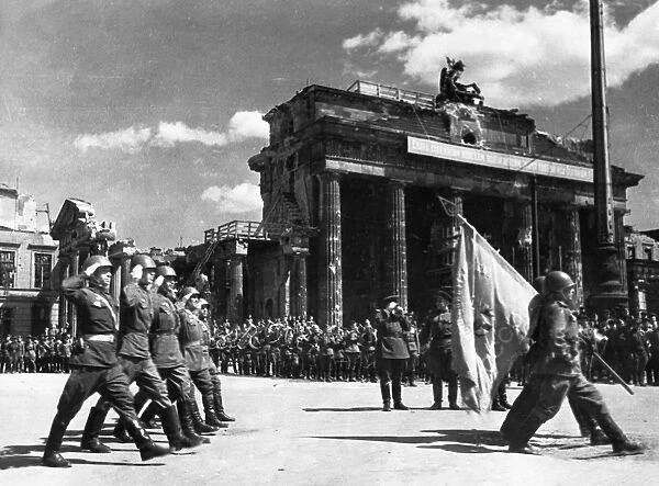 Soviet red army troops during a victory parade in front of the brandenburg gate in berlin, germany at the end of world war 2, may 20, 1945