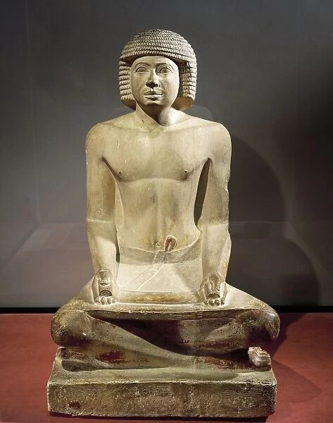 Statue of a scribe sitting with papyrus on his knees, painted limestone