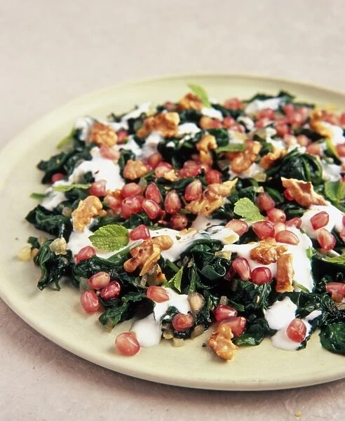 Syrian spinach, walnut and pomegranate salad with yoghurt and mint leaves
