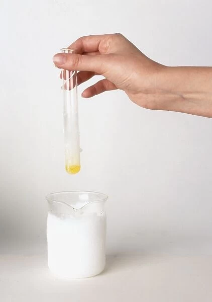 Test tube of chlorine condensed into liquid by dipping into jug of dry ice