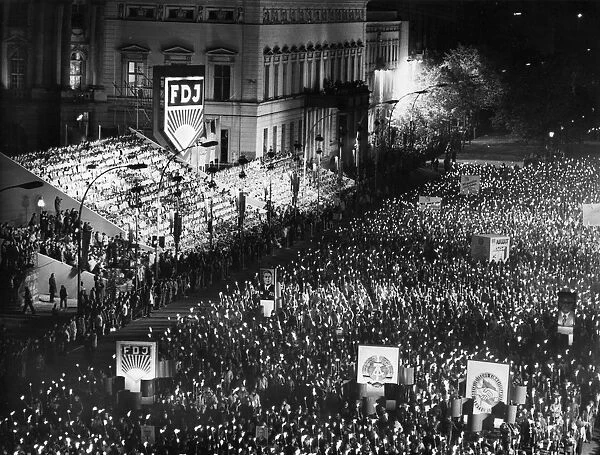 A torchlight procession of free german youth organization members in honor of the 30th anniversary of the founding of the gdr on unter der linden avenue in berlin, october 10, 1979