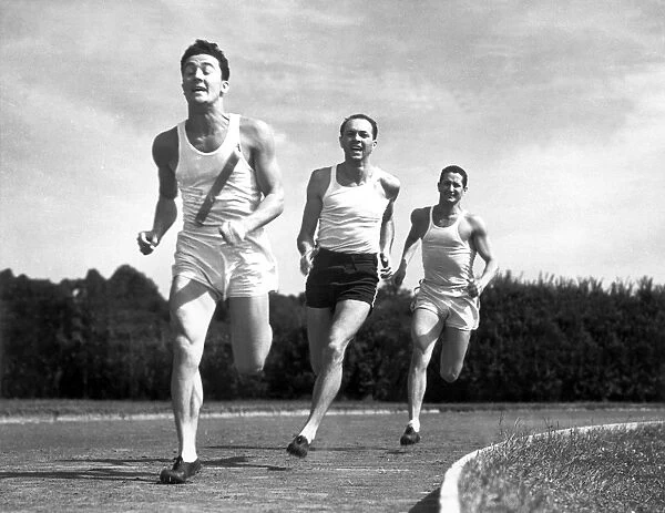 Three track runners competing in race