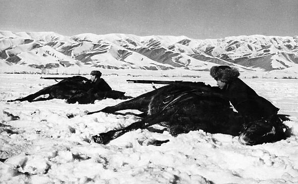 Training of red army reserves, the ossoaviakhim riding club of the kirghiz soviet socialist republic is training youths of call age and men undergoing universal military training, trainees firing from behind horses, march 1942